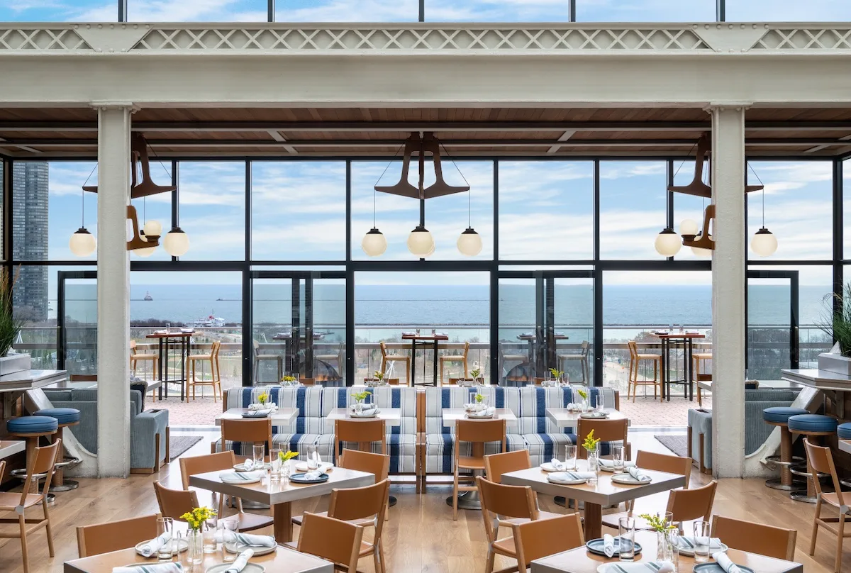 Cindy's Rooftop, featuring floor-to-ceiling windows overlooking blue sky