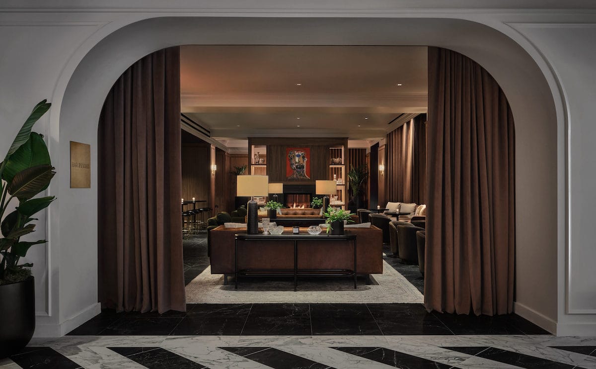 A soft, curved archway that opens up to a luxury living area inside Pendry Chicago