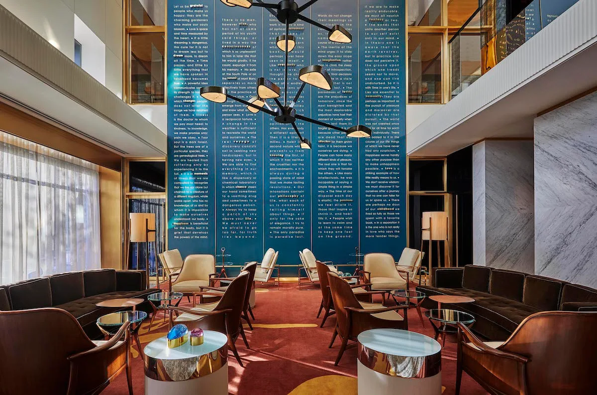 Viceroy Chicago lobby, with plague at the back and cool furniture and sharp lighting