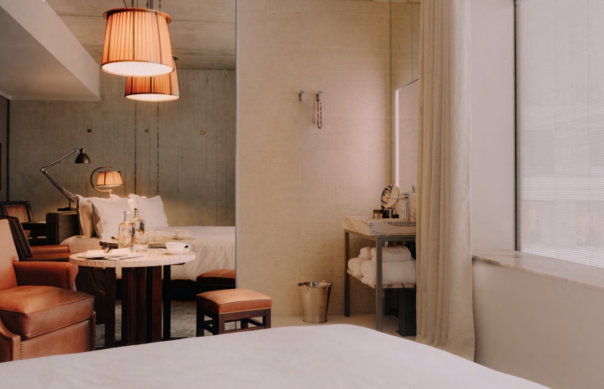 A modern, clean and minimalist guestroom inside Maison Heler, designed by Philippe Starck