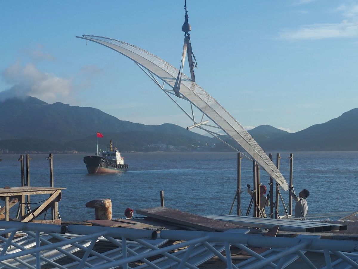 Installation of the Seaside Pavilion, showing large blade lifted by crane