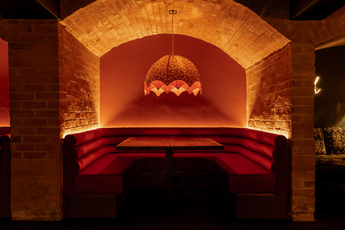 The pendants, sourced from Anna Hayman Designs in cave-like bar setting