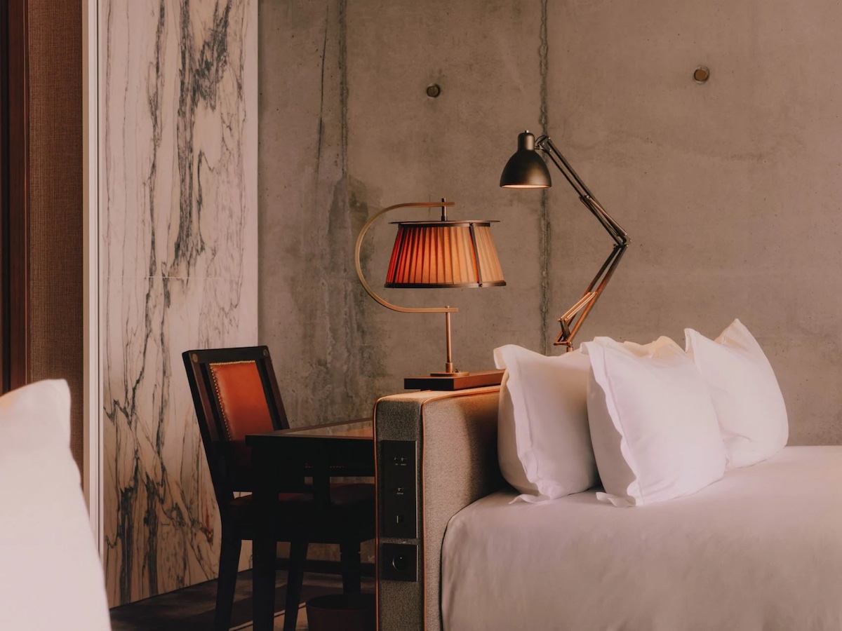Close up of guestroom inside Maison Heler - with Philippe Starck lighting and soft bedding
